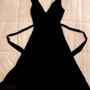 Elegant black flowing party dress with tie in the back. Barely worn.